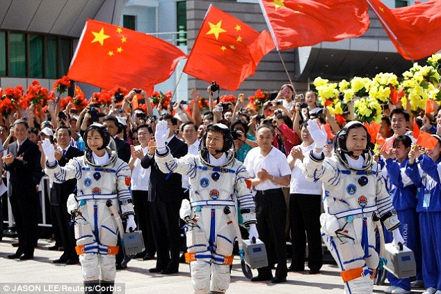 Chinese Taikonauts (astronauts) Jing Haipeng, Liu Wang and Liu Yang ahead of a space exploration launch in June 2012