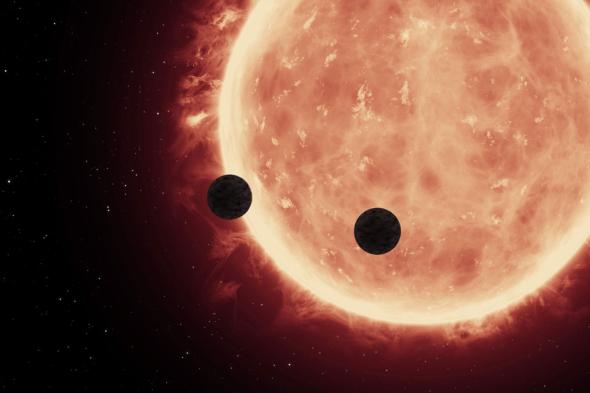 This artist's view shows two planets passing in front of their host star TRAPPIST-1. ILLUSTRATION BY NASA, ESA, AND STSCI